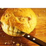 The Best Of Low Carb Product Reviews. Face carved into a round loaf of bread with a knife in its mouth.